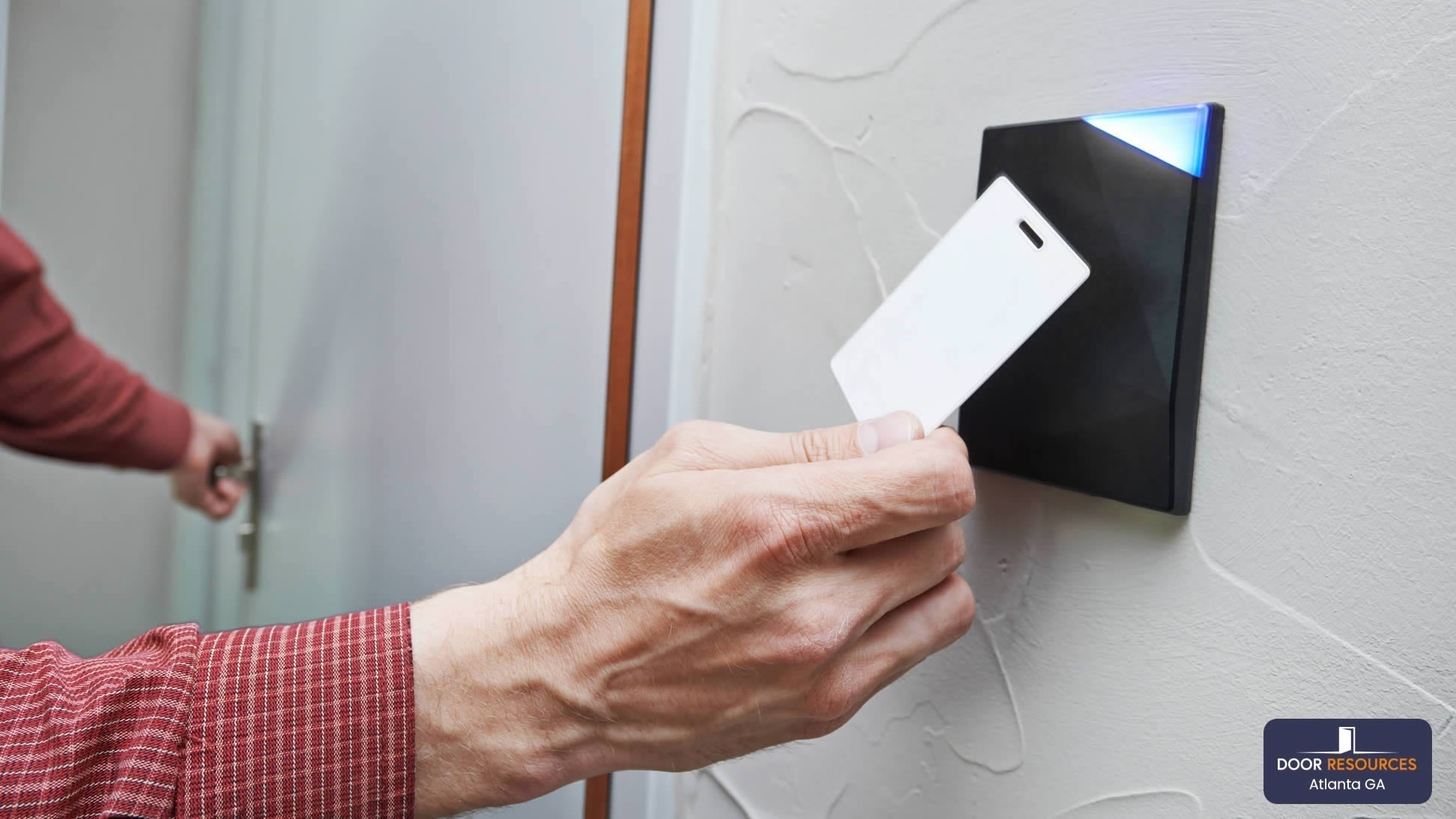 Man waving his access control card in front of a reader